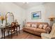 Inviting living room featuring hardwood floors, a sofa, and natural light from the arched window at 41 Sunfield Dr., Calabash, SC 28467