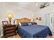 The main bedroom offers a king bed with a blue comforter, vaulted ceilings, and a decorative display shelf at 41 Sunfield Dr., Calabash, SC 28467