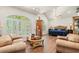 Spacious main bedroom featuring a sitting area, vaulted ceilings, and natural light from the arched windows at 41 Sunfield Dr., Calabash, SC 28467