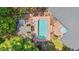 Aerial view of a backyard pool area featuring a rectangular pool, a lounge area, and lush landscaping at 41 Sunfield Dr., Calabash, SC 28467