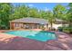 Beautiful backyard with a pool, lush landscaping, and a screened-in porch at 41 Sunfield Dr., Calabash, SC 28467
