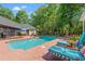 Inviting pool area features lounge chairs, lush landscaping, and a serene backyard setting at 41 Sunfield Dr., Calabash, SC 28467