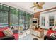 Bright sunroom with ceiling fan, a view of the pool and backyard, and comfortable seating at 41 Sunfield Dr., Calabash, SC 28467