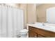 Clean bathroom featuring a toilet, shower with white curtain, and a vanity with a dark-stained wood cabinet at 413 Goldenrod Circle # 2B, Little River, SC 29566