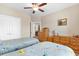 Comfortable bedroom featuring two beds, ceiling fan, dresser, closet, and neutral walls with hanging art at 413 Goldenrod Circle # 2B, Little River, SC 29566