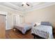Bright bedroom with two twin beds, wood floors, and a tray ceiling at 413 Goldenrod Circle # 2B, Little River, SC 29566