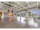 Expansive community room with soaring ceilings, ceiling fan, polished concrete floors, and multiple seating areas at 413 Goldenrod Circle # 2B, Little River, SC 29566