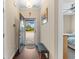 Open entryway featuring hardwood floors, a bench, neutral walls with hanging art, with outside view of the lawn at 413 Goldenrod Circle # 2B, Little River, SC 29566
