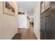 View of the home entryway featuring hardwood floors, neutral walls with hanging art, and a bench at 413 Goldenrod Circle # 2B, Little River, SC 29566