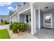 Inviting front porch featuring a slate-gray surface, rocking chairs, and manicured landscaping along a cement pathway at 413 Goldenrod Circle # 2B, Little River, SC 29566