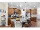 Spacious kitchen with an island, granite countertops, dark wood cabinets, and stainless steel appliances at 413 Goldenrod Circle # 2B, Little River, SC 29566