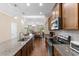 Open kitchen with granite countertops, stainless appliances, and view to living area at 413 Goldenrod Circle # 2B, Little River, SC 29566