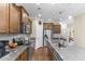 Modern kitchen featuring granite countertops, stainless steel appliances, and wood cabinets at 413 Goldenrod Circle # 2B, Little River, SC 29566