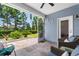Screened-in patio with comfortable seating and view of the well-maintained backyard and trees at 413 Goldenrod Circle # 2B, Little River, SC 29566
