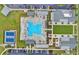 Aerial view of the community pool and surrounding amenities, including lawn and lounge areas at 413 Goldenrod Circle # 2B, Little River, SC 29566