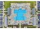 Aerial view of a luxurious community swimming pool with lounge chairs and umbrellas surrounded by lush landscaping at 413 Goldenrod Circle # 2B, Little River, SC 29566