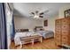Cozy bedroom with two beds, ceiling fan, hardwood floors and natural light from window with curtains at 4189 Schoolhouse Circle, Little River, SC 29566