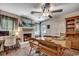 Dining area with a brick fireplace, hardwood floors, natural light, and an adjacent workspace at 4189 Schoolhouse Circle, Little River, SC 29566