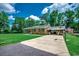 View of a long driveway and basketball hoop leading to the home, surrounded by lush greenery at 4189 Schoolhouse Circle, Little River, SC 29566