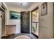 Inviting entryway featuring a slate floor, painting, and an open door to a covered patio at 4189 Schoolhouse Circle, Little River, SC 29566
