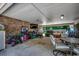 Spacious garage with brick walls, a television, and plenty of room for storage and activities at 4189 Schoolhouse Circle, Little River, SC 29566