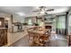 Open-concept kitchen and dining area feature updated appliances, tile floors, and brick fireplace at 4189 Schoolhouse Circle, Little River, SC 29566
