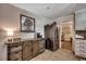 Additional kitchen space features custom cabinetry, stainless steel refrigerator, and tile floors at 4189 Schoolhouse Circle, Little River, SC 29566