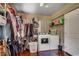 Well-equipped laundry room with washer, dryer, storage shelves, and hanging racks at 4189 Schoolhouse Circle, Little River, SC 29566