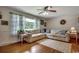 Inviting living room featuring a plush sectional sofa, hardwood floors, and natural light from the window at 4189 Schoolhouse Circle, Little River, SC 29566