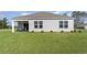 Well-maintained backyard featuring a covered patio, lush green grass, and privacy at 422 Glade Ct., Loris, SC 29569