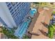 Stunning aerial view of pools and oceanfront high-rise condo showcasing its blue balconies and convenient access to amenities at 5511 N Ocean Blvd. # 1801, Myrtle Beach, SC 29577