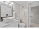 Well-lit bathroom with marble tile, vessel sink, framed mirror, commode, and open shower with glass door at 5511 N Ocean Blvd. # 1801, Myrtle Beach, SC 29577
