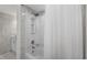 Bright and renovated shower and tub combination features white tile and marble walls with a vessel sink at 5511 N Ocean Blvd. # 1801, Myrtle Beach, SC 29577
