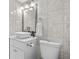 Well-lit bathroom with marble tile, vessel sink, framed mirror, commode, and open shower with glass door at 5511 N Ocean Blvd. # 1801, Myrtle Beach, SC 29577