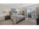 Comfortable bedroom featuring a bed, ceiling fan, and a workspace with a beautiful view outside the window at 5511 N Ocean Blvd. # 1801, Myrtle Beach, SC 29577