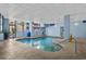 Inviting indoor pool featuring clear water, large windows offering ample light, and comfortable lounge seating at 5511 N Ocean Blvd. # 1801, Myrtle Beach, SC 29577