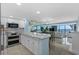 Modern kitchen with granite countertops, stainless appliances, and open floor plan with dining and ocean views at 5511 N Ocean Blvd. # 1801, Myrtle Beach, SC 29577