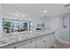 Open kitchen features white cabinets, granite countertops, flows into dining and living with ocean views at 5511 N Ocean Blvd. # 1801, Myrtle Beach, SC 29577
