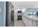 Well-equipped kitchen with stainless steel refrigerator and oven, white cabinets, and bright, open layout at 5511 N Ocean Blvd. # 1801, Myrtle Beach, SC 29577