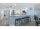 Open-concept kitchen with breakfast bar, granite countertops, stainless steel appliances, and stylish barstool seating at 5511 N Ocean Blvd. # 1801, Myrtle Beach, SC 29577