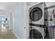 Hallway laundry closet equipped with a silver stackable washer and dryer set at 5511 N Ocean Blvd. # 1801, Myrtle Beach, SC 29577