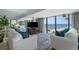 Bright living room with cozy seating, large windows overlooking the ocean, and stylish decor at 5511 N Ocean Blvd. # 1801, Myrtle Beach, SC 29577