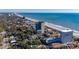 Expansive aerial view of the property with lush greenery, ocean, and surrounding buildings at 5523 North Ocean Blvd. # 803, Myrtle Beach, SC 29577