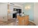 Efficient kitchen with black appliances and bar-height dining table with chairs at 5523 North Ocean Blvd. # 803, Myrtle Beach, SC 29577
