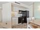 Well-lit kitchen features white cabinets, black appliances, and a stylish backsplash at 5523 North Ocean Blvd. # 803, Myrtle Beach, SC 29577