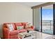 Inviting living room with a couch, coffee table, and sliding glass doors to a balcony with ocean views at 5523 North Ocean Blvd. # 803, Myrtle Beach, SC 29577