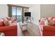 Cozy living room featuring stylish sofas, wood-look floors, TV, and access to a balcony with ocean views at 5523 North Ocean Blvd. # 803, Myrtle Beach, SC 29577