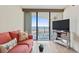 Comfortable living area showcasing bright couches, wood-style floors, and balcony access with ocean views at 5523 North Ocean Blvd. # 803, Myrtle Beach, SC 29577