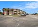 A bright sunny day with an exterior view of the condo buildings and parking near a beach at 5601 N Ocean Blvd. # E-113, Myrtle Beach, SC 29577