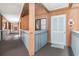Hallway view featuring wood paneled walls and light blue painted door and trim in a beach community building at 5601 N Ocean Blvd. # E-113, Myrtle Beach, SC 29577